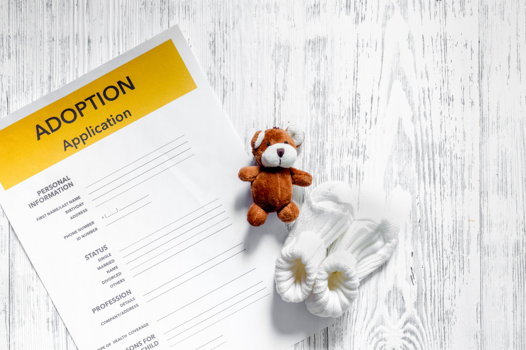 Child adoption application with a small teddy and socks