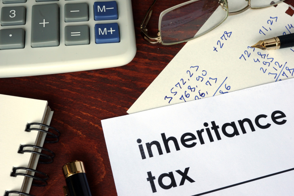 inheritance tax printed on paper with a pen and calculator